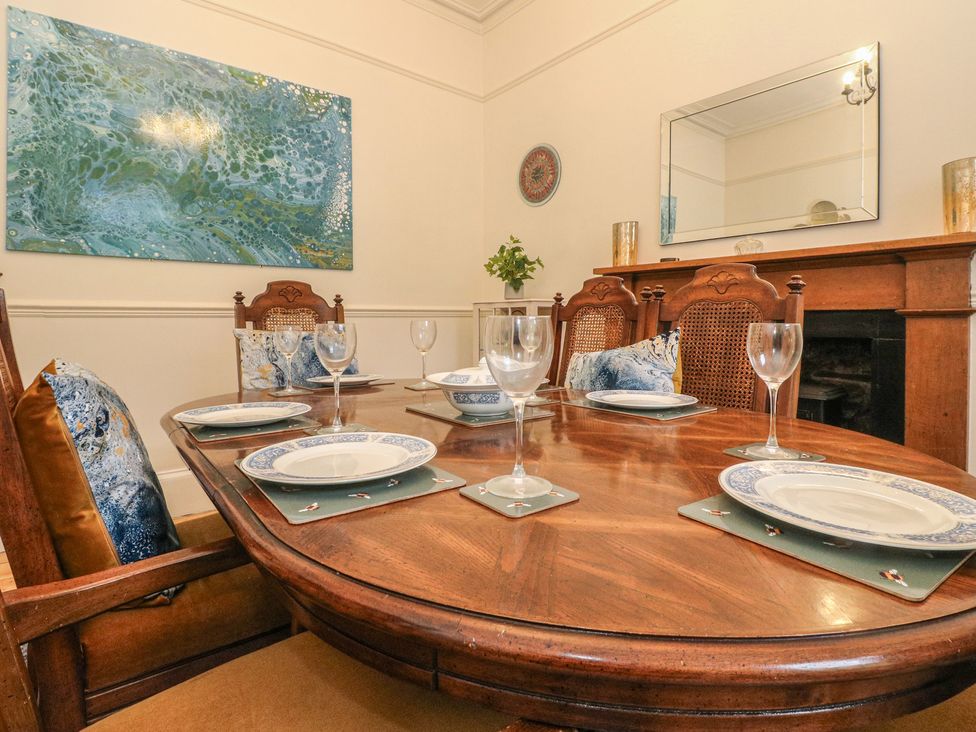 A dining room with a table set for dinner at Rowan Tree House Brechin