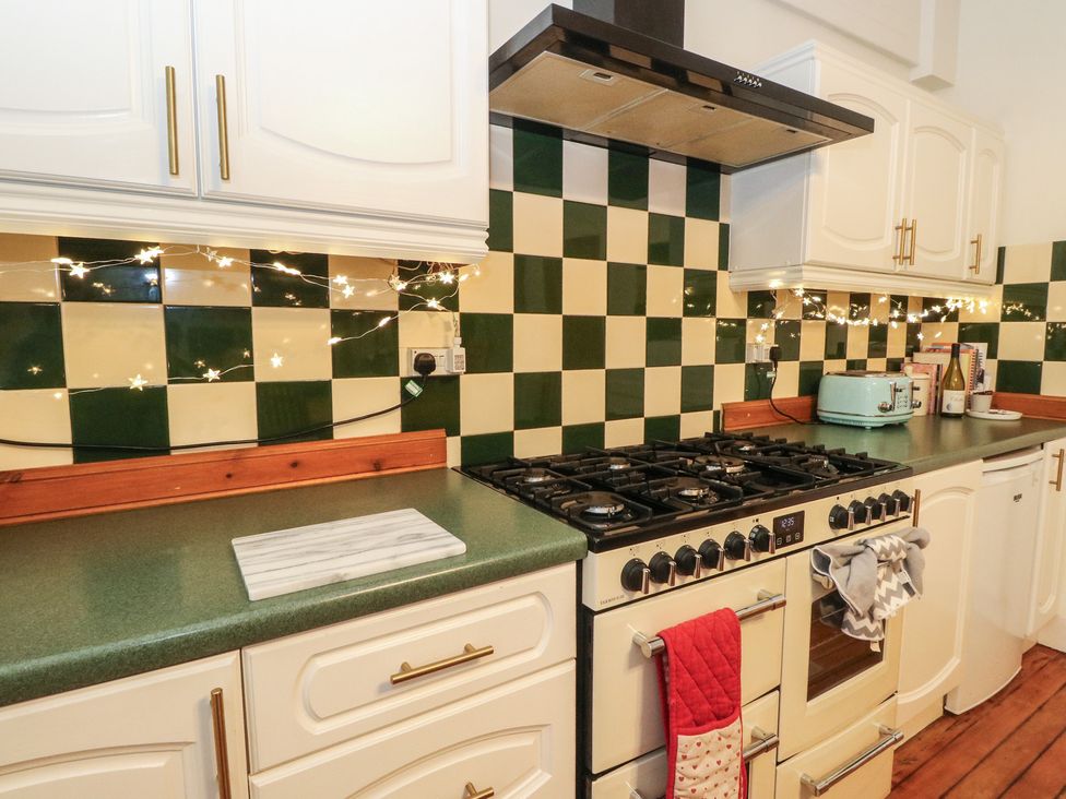 A kitchen with a stove and appliances at Rowan Tree House in Brechin