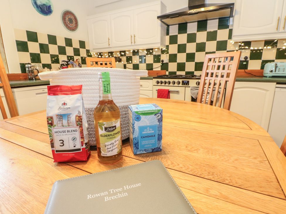 A kitchen with a dining table and items on it at Rowan Tree House Brechin