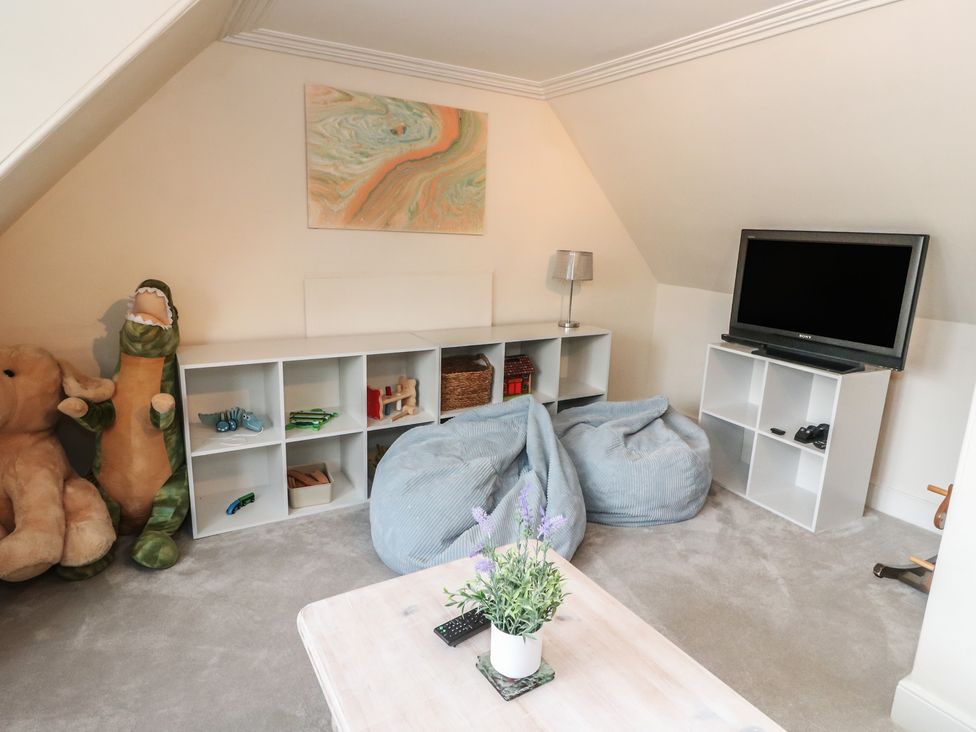 A playroom with a television and bean bags at Rowan Tree House in Brechin