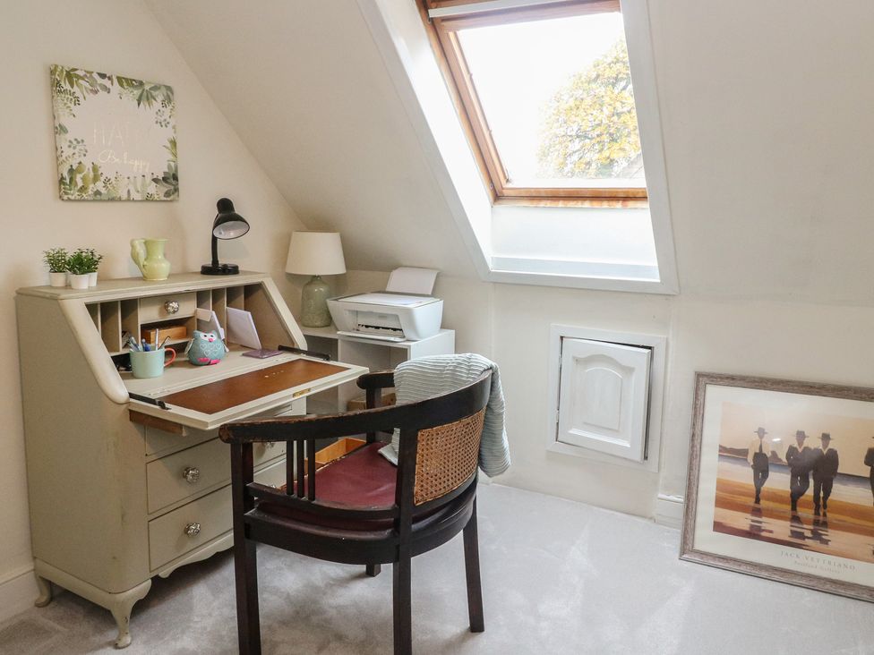 An office space with a desk and chair at Rowan Tree House in Brechin