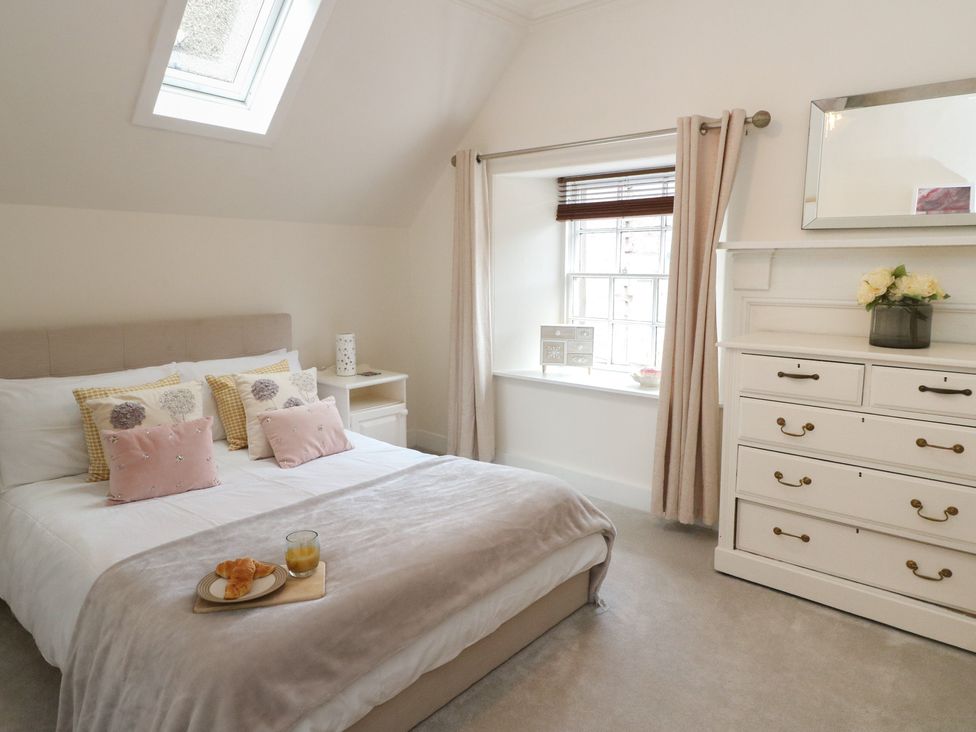 A bedroom with a bed and nightstand at Rowan Tree House in Brechin