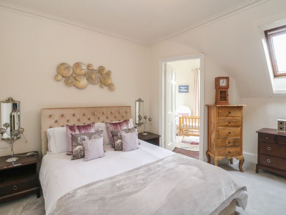 A bedroom with a bed and a drawer cabinet at Rowan Tree House in Brechin