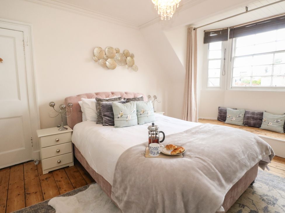 A bedroom with a bed and nightstand at Rowan Tree House Brechin