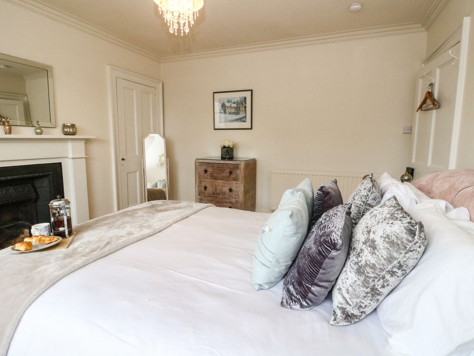 A bedroom with a bed and pillows at Rowan Tree House in Brechin