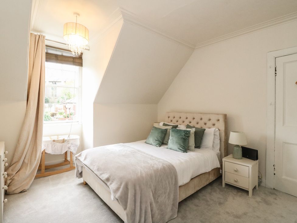 A bedroom with a bed and window at Rowan Tree House Brechin