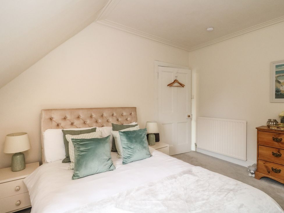 A bedroom with a bed and dresser at Rowan Tree House Brechin