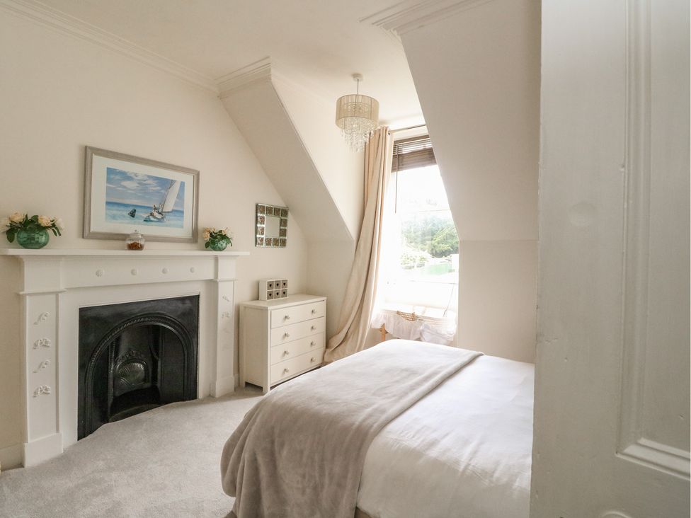 A bedroom featuring a bed and a fireplace at Rowan Tree House in Brechin