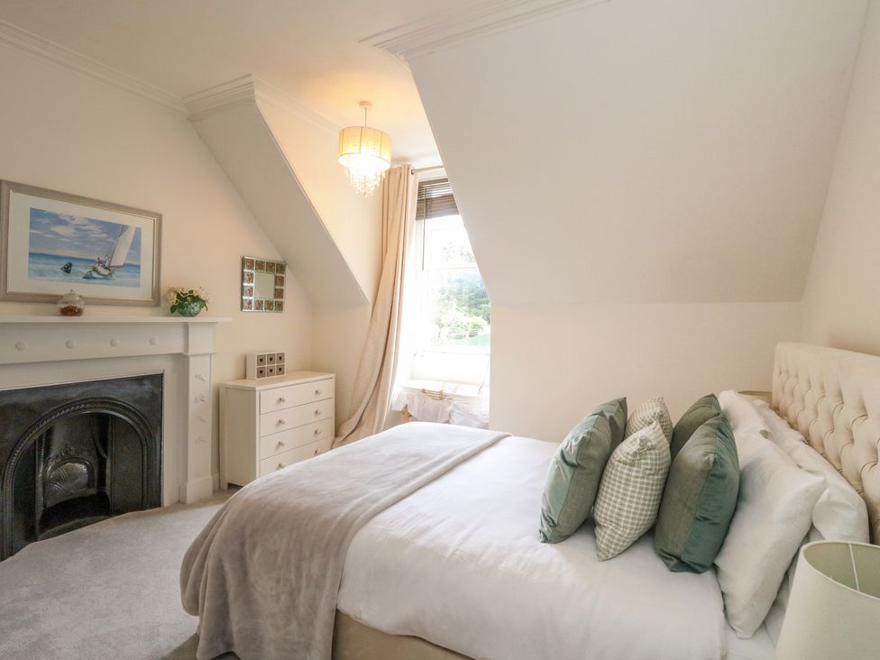 A bedroom with a bed and decorative elements at Rowan Tree House in Brechin