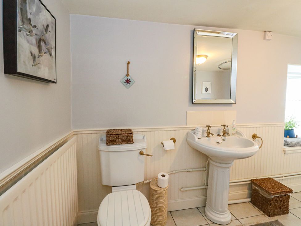 A bathroom with a toilet and sink at Rowan Tree House in Brechin