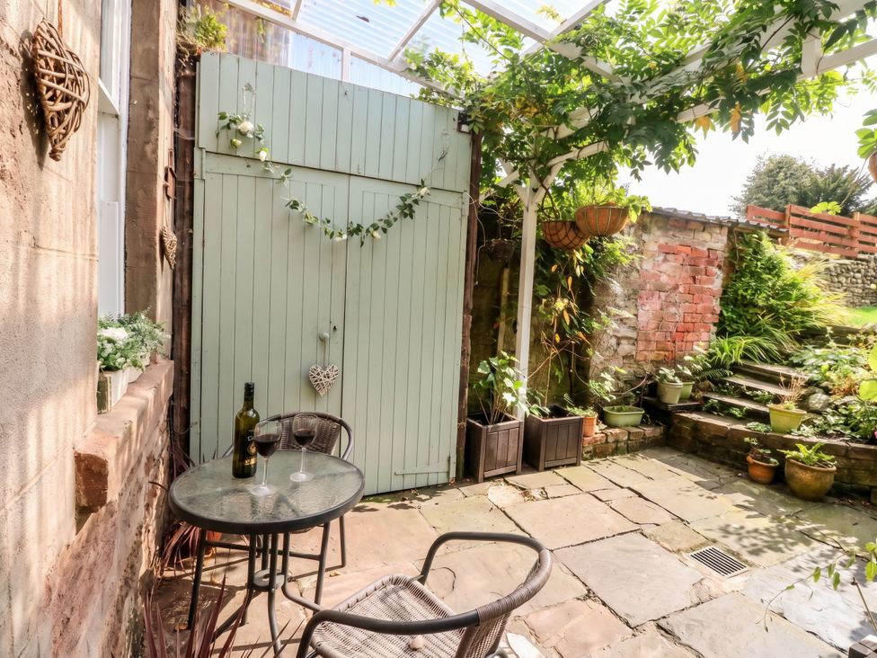 A garden with a table and chairs at Rowan Tree House Brechin