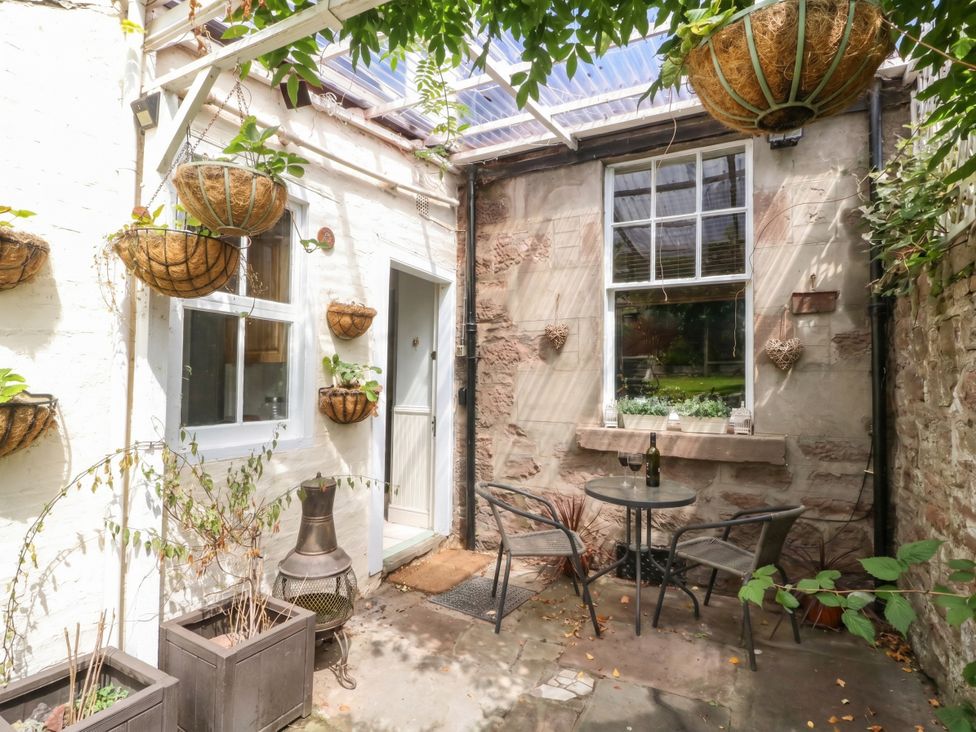An outdoor area with a table and chairs at Rowan Tree House Brechin