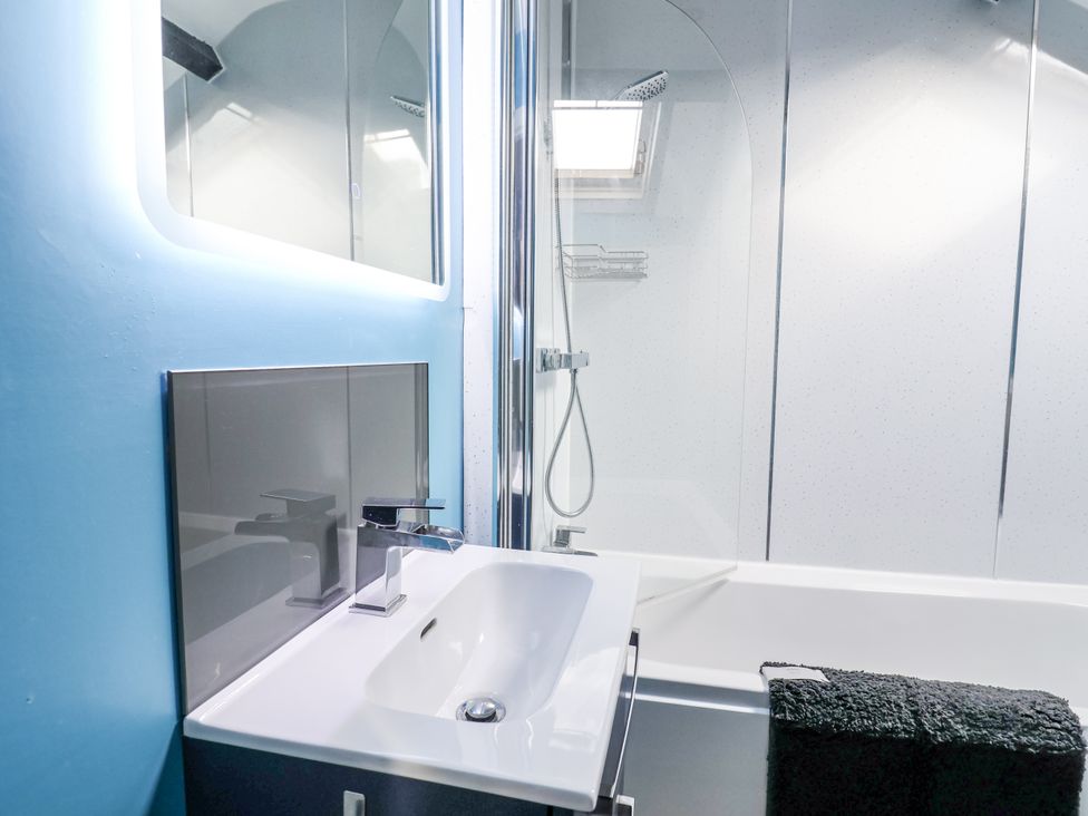 A bathroom with a sink and shower at Rushmoor Cottage in Colaton Raleigh