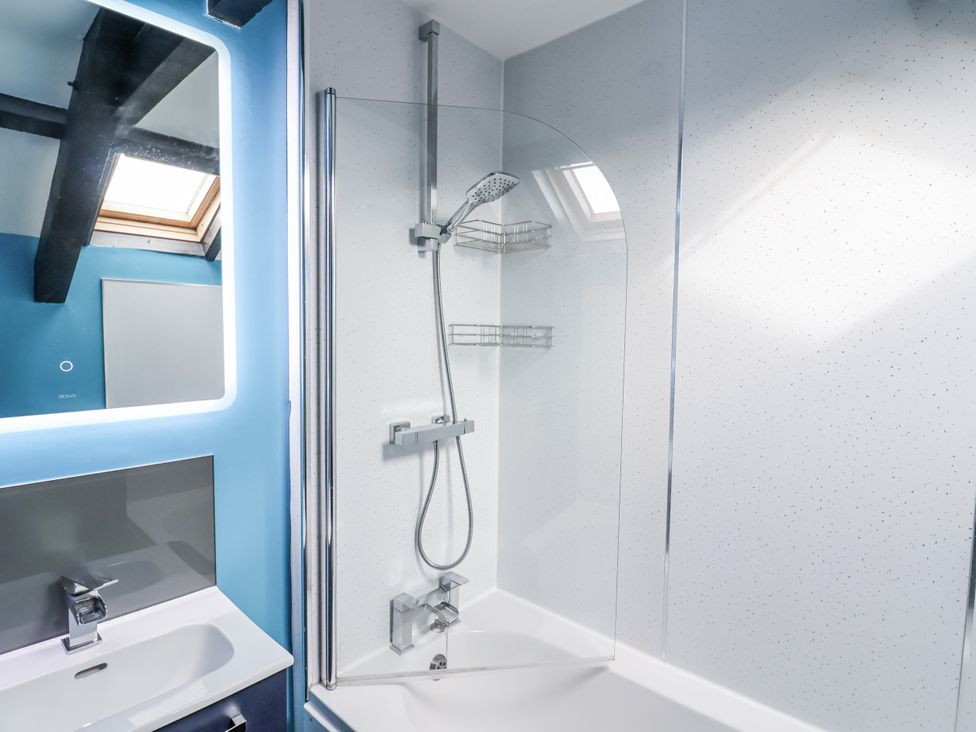 A bathroom with a shower and sink at Rushmoor Cottage in Colaton Raleigh