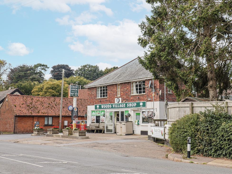 A village shop with a parking area at Woods Village Shop in Colaton Raleigh