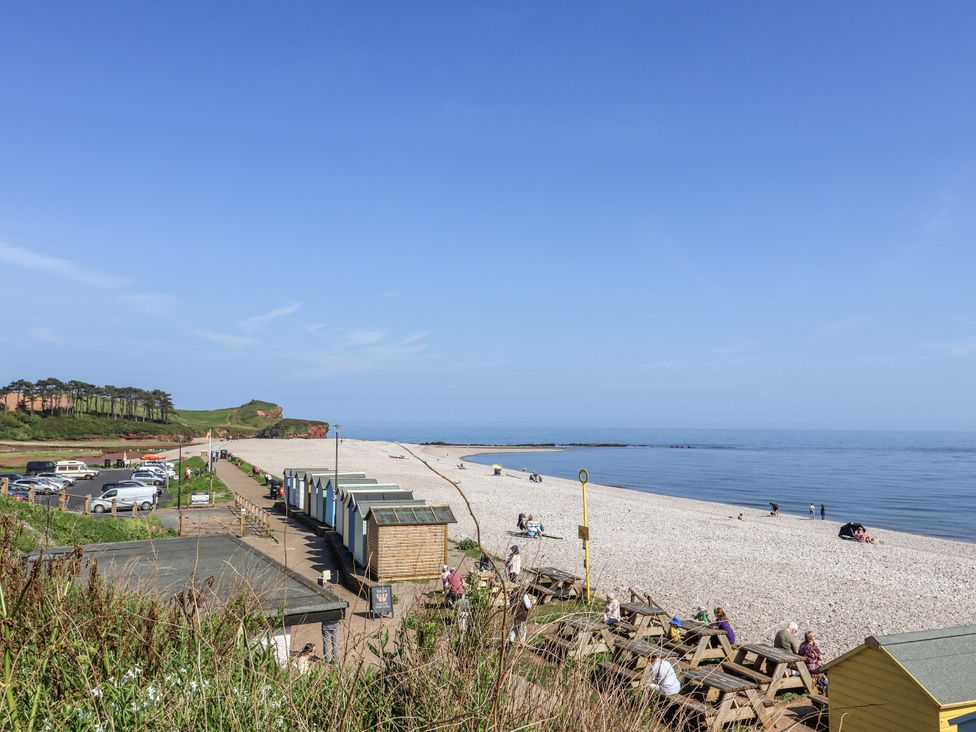 A beach with huts and people relaxing at Rushmoor Cottage Colaton Raleigh
