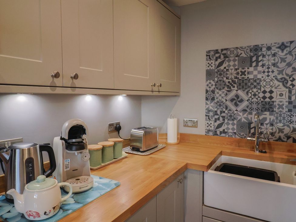 A kitchen with appliances and a sink at Rushmoor Cottage in Colaton Raleigh
