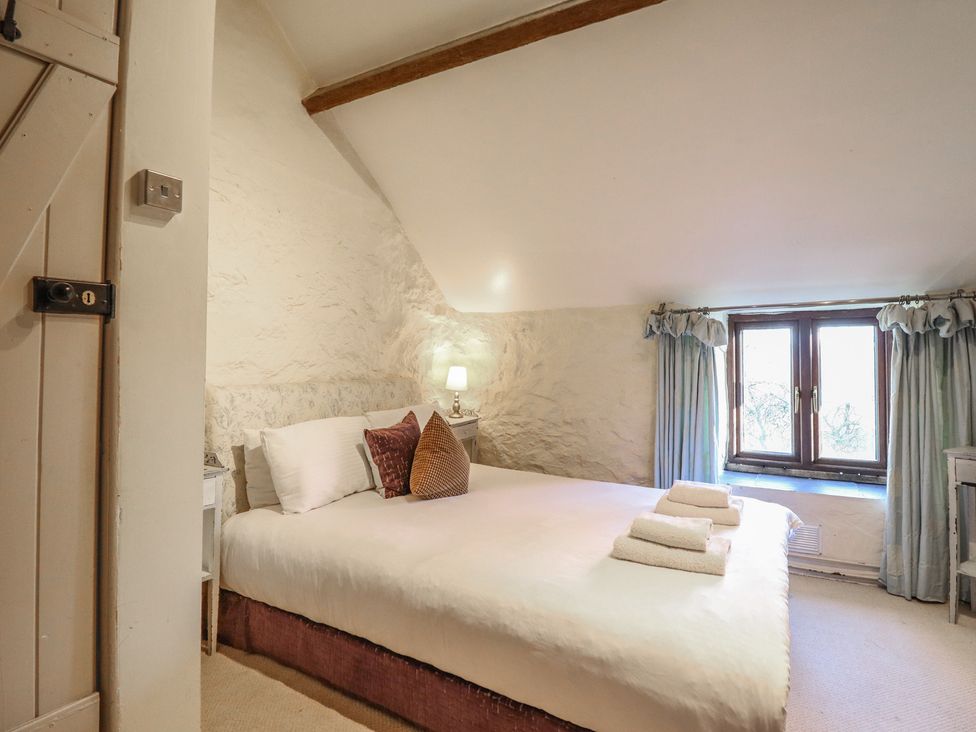 A bedroom with a bed and window at 1 Fron Uchaf in Parc near Bala