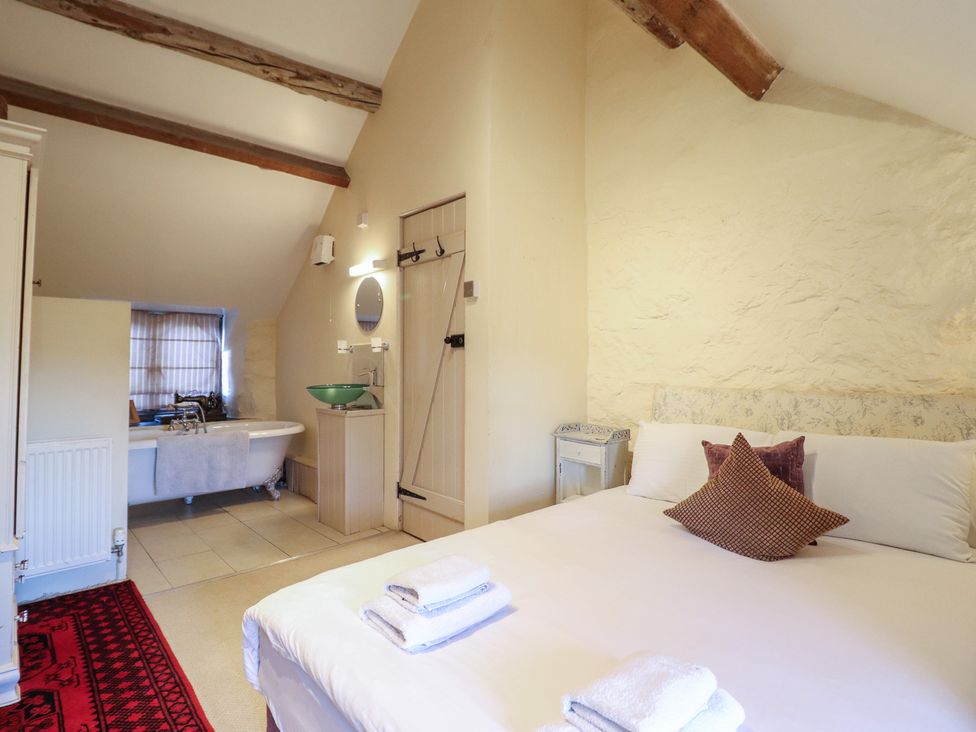 A bedroom with a bed and attached bathroom at 1 Fron Uchaf in Parc near Bala