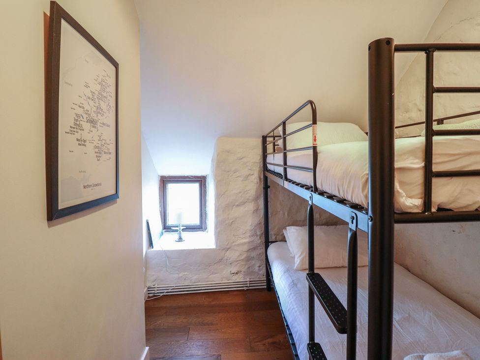 A bedroom with a bunk bed and a window at 1 Fron Uchaf in Parc near Bala