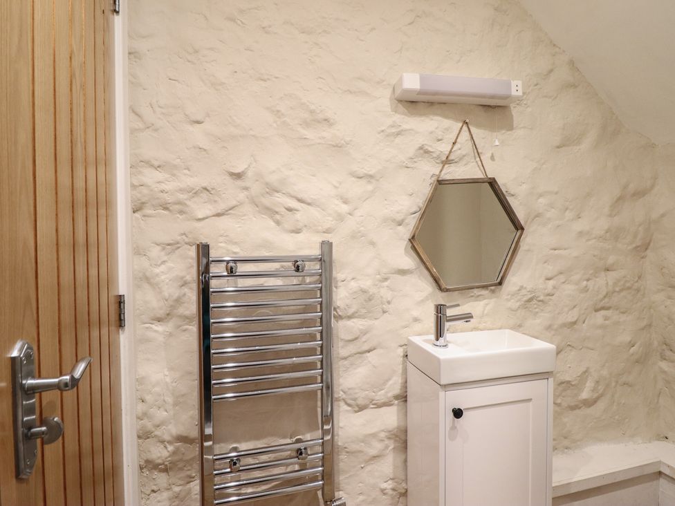 A bathroom with a sink and towel radiator at 1 Fron Uchaf Parc near Bala