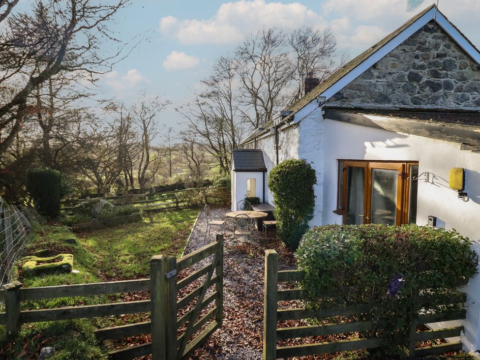 An outdoor area with a table and chairs at 1 Fron Uchaf in Parc near Bala