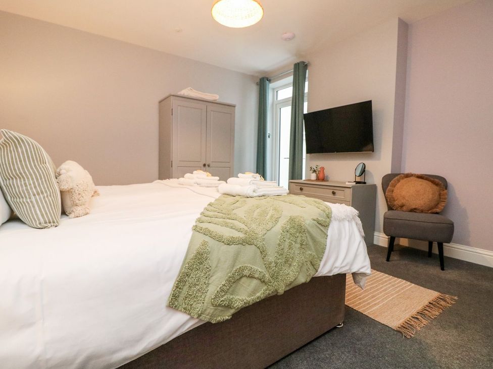 A bedroom with a bed and television at Klysa in Camborne