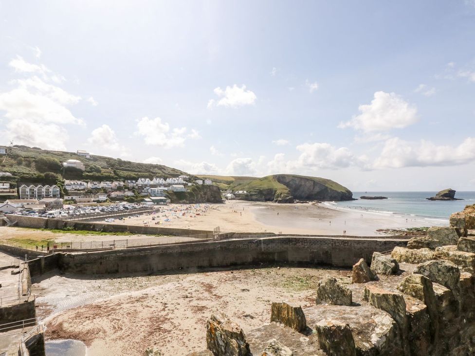 A beach with houses and hills in the background at Klysa in Camborne