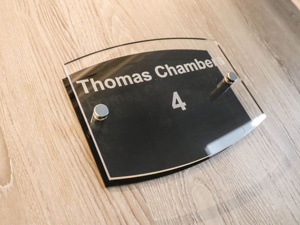 A sign displaying Thomas Chambers and room number 4 at Thomas Chambers in Camborne