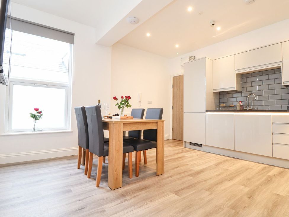A dining room with a table and chairs at West Chambers in Camborne