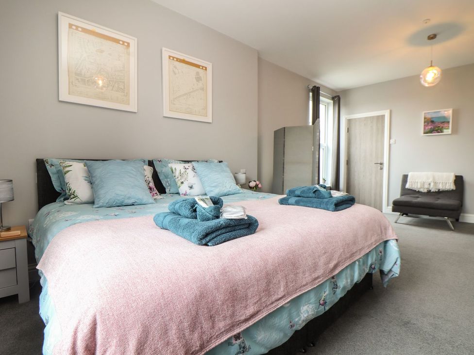 A bedroom featuring a bed with pillows and a throw blanket at West Chambers in Camborne
