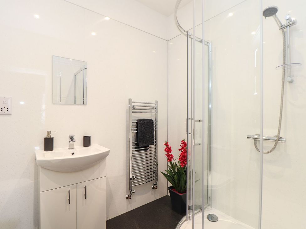 A bathroom featuring a sink, shower, and towel rail at West Chambers Camborne