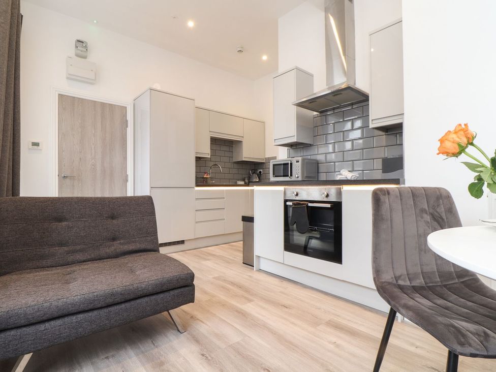 A kitchen with cabinets and appliances at Baker Chambers in Camborne