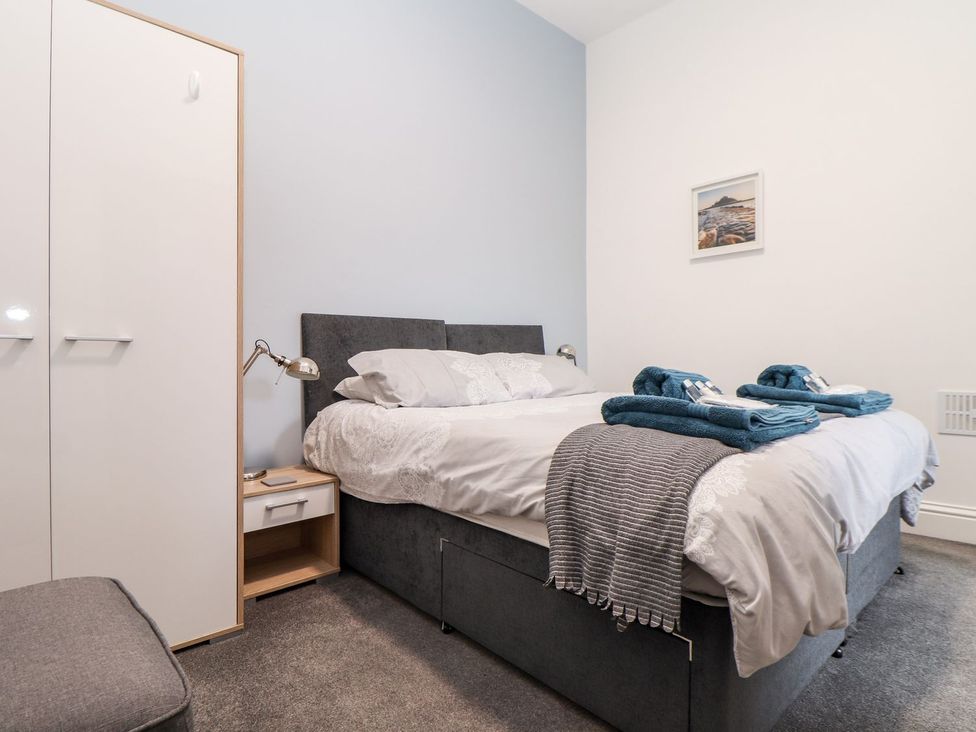 A bedroom with a bed and nightstand at Teylu in Camborne