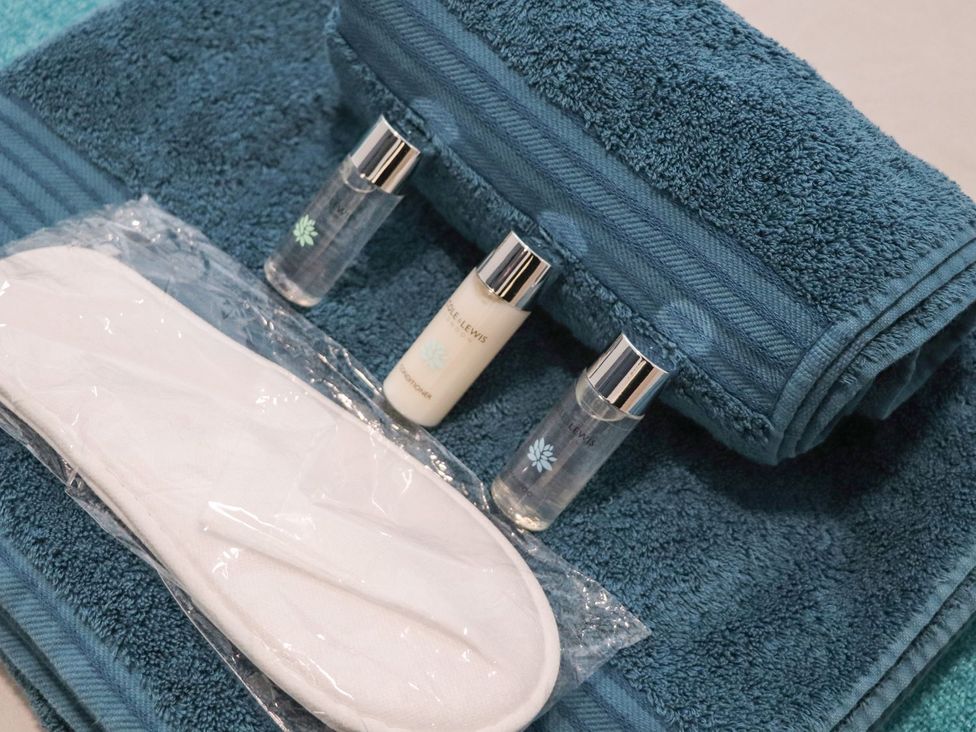 Bottles and towels on a surface at Teylu in Camborne
