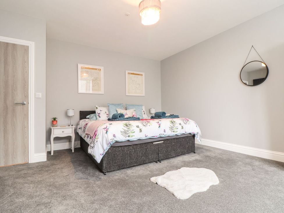 A bedroom with a bed and nightstand at Battell Chambers in Camborne