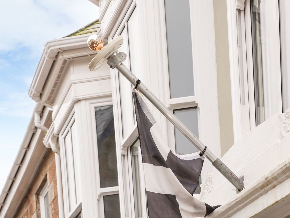 A flag on a pole outside a building at Daniel Chambers Camborne