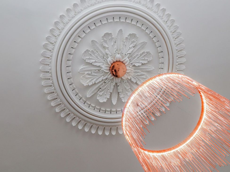 A ceiling with an ornate design and a chandelier at Mews Retreat in Camborne