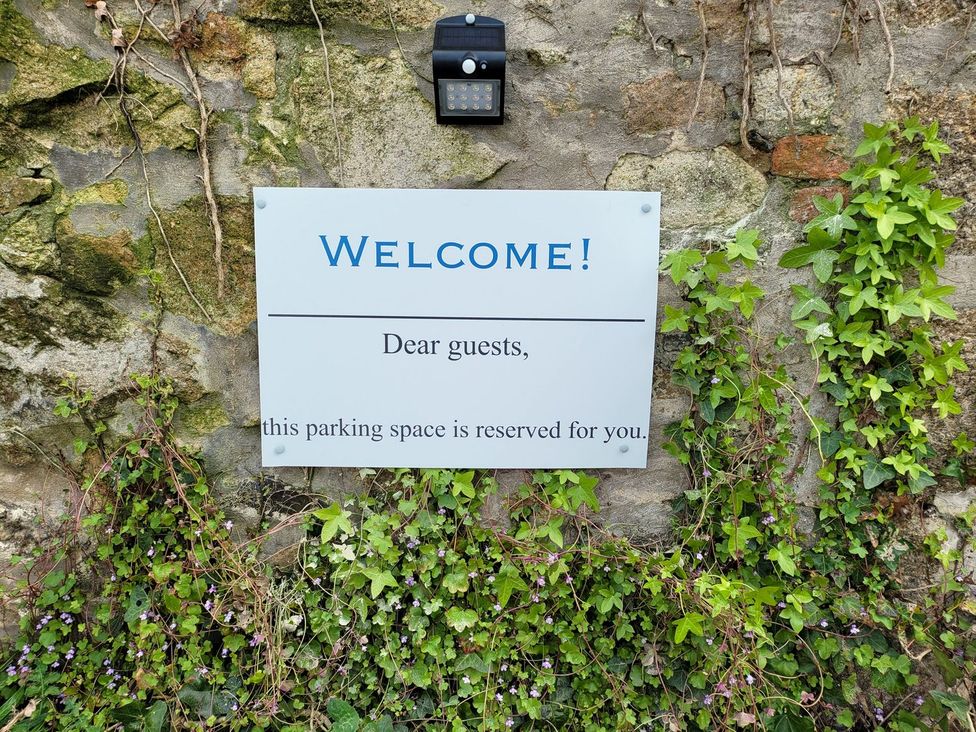 A welcome sign indicating a reserved parking space at Mews Retreat in Camborne