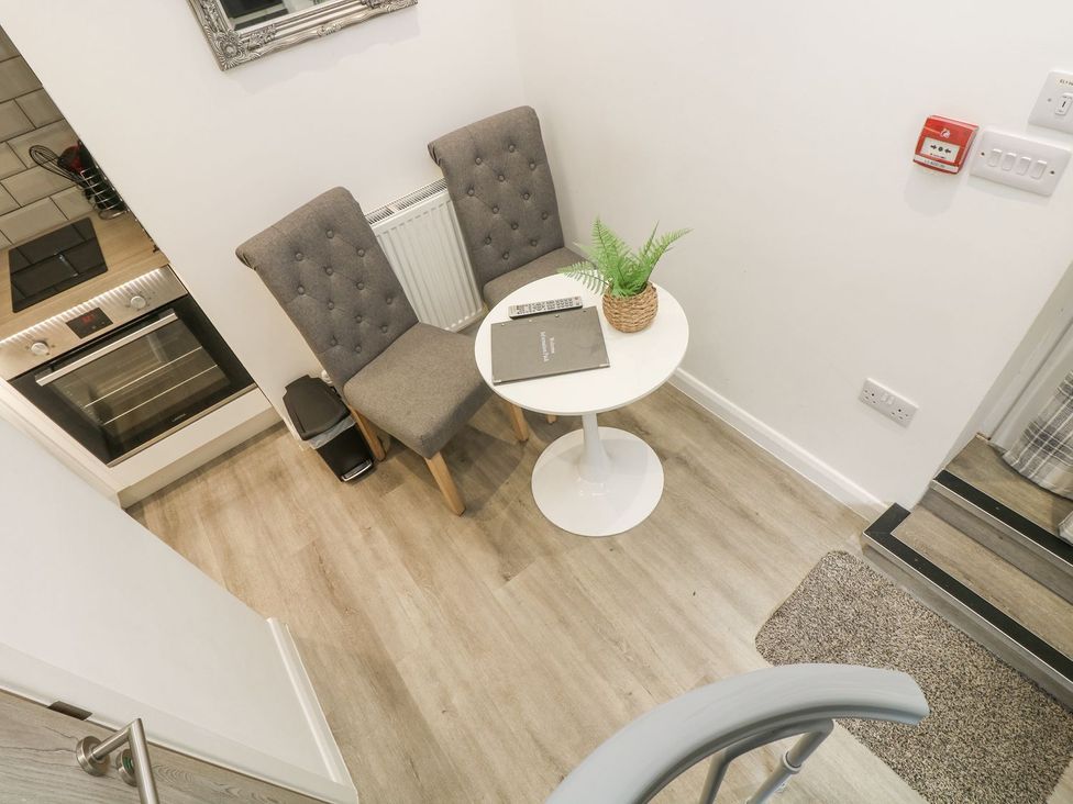 A kitchen with a table and chairs at The Snug in Camborne