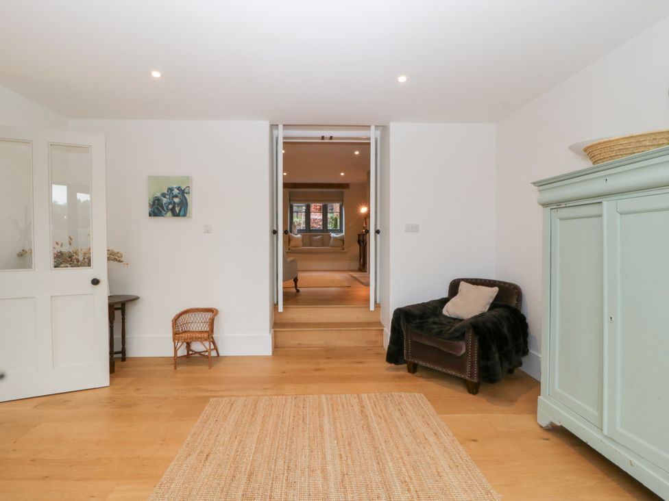 An entryway with a door and a small chair at Spring View in Tetbury