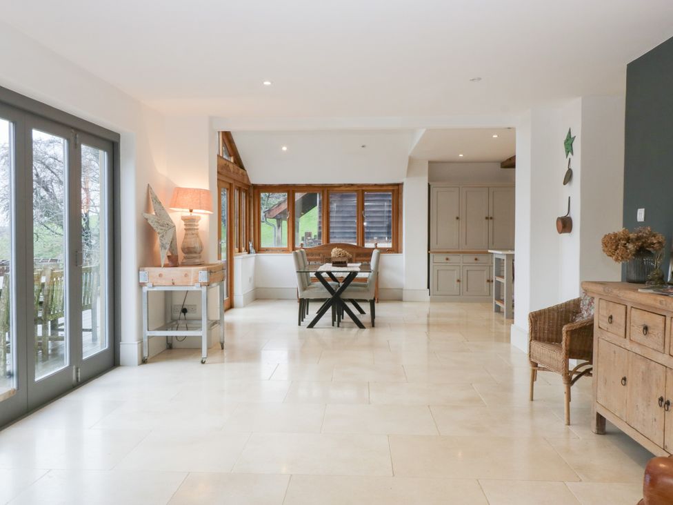 A dining room with a table and chairs at Spring View in Tetbury