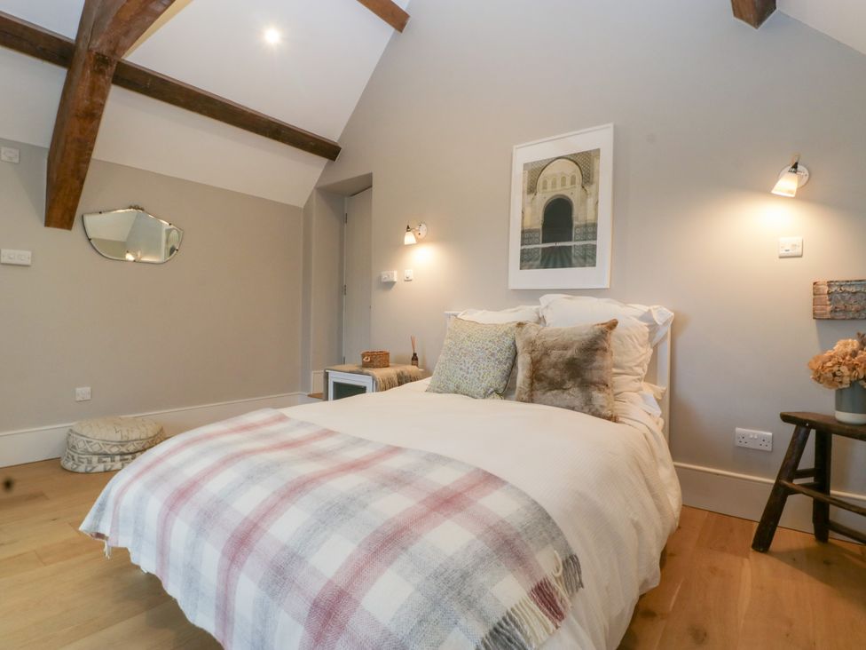 A bedroom with a bed and a bedside table at Spring View in Tetbury