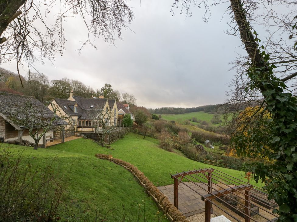 A house surrounded by grass and trees at Spring View in Tetbury