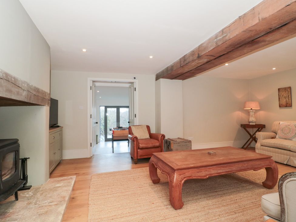 A living room with a sofa and coffee table at Spring View in Kingscote, Gloucestershire