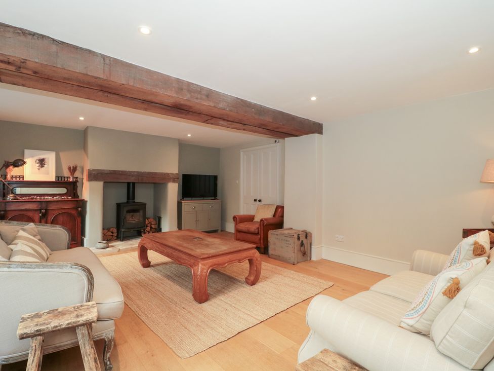 A living room with a sofa and coffee table at Spring View in Kingscote, Gloucestershire