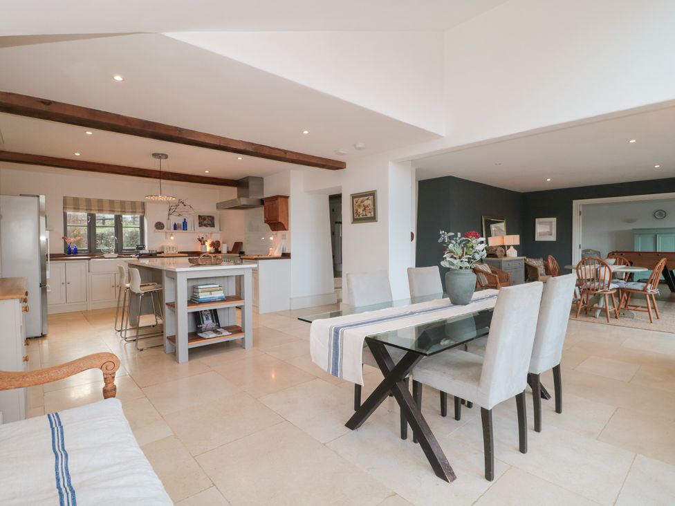 A kitchen and dining area with a table and chairs at Spring View in Kingscote, Gloucestershire