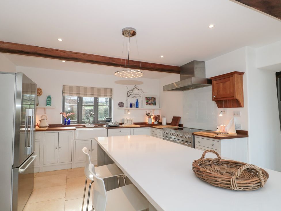 A kitchen with modern appliances and a countertop at Spring View in Kingscote, Gloucestershire