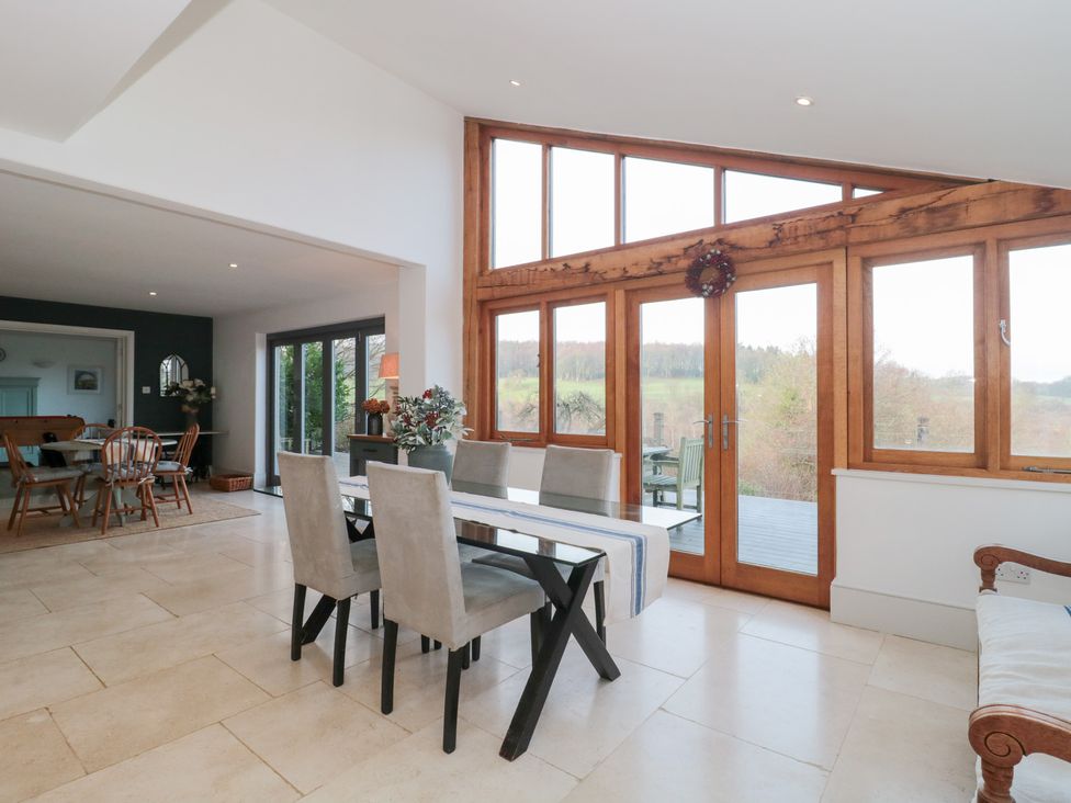 A dining room with a table and chairs at Spring View in Kingscote, Gloucestershire