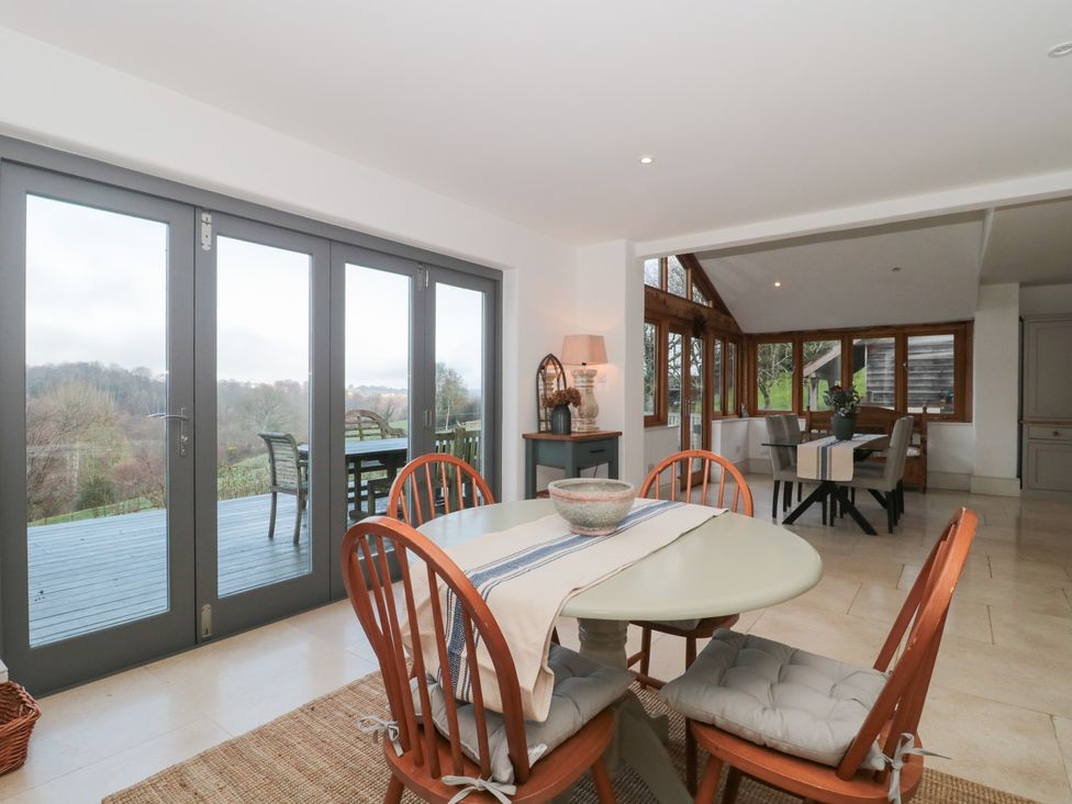 A dining room with a table and chairs at Spring View in Kingscote, Gloucestershire